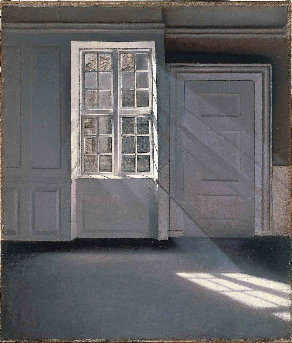 Vilhelm Hammershøi painting of an empty room with bare floorboards and a closed door, lit by sunbeams streaming through a tall window