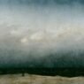 A tiny figure in a dark robe stands alone on a pale strip of dune beside a dark sea, under a vast grey sky that fills most of the painting.